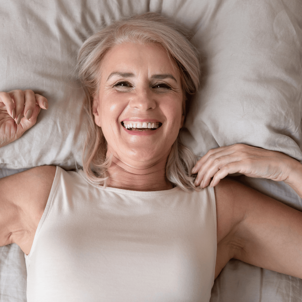 happy woman laying in bed